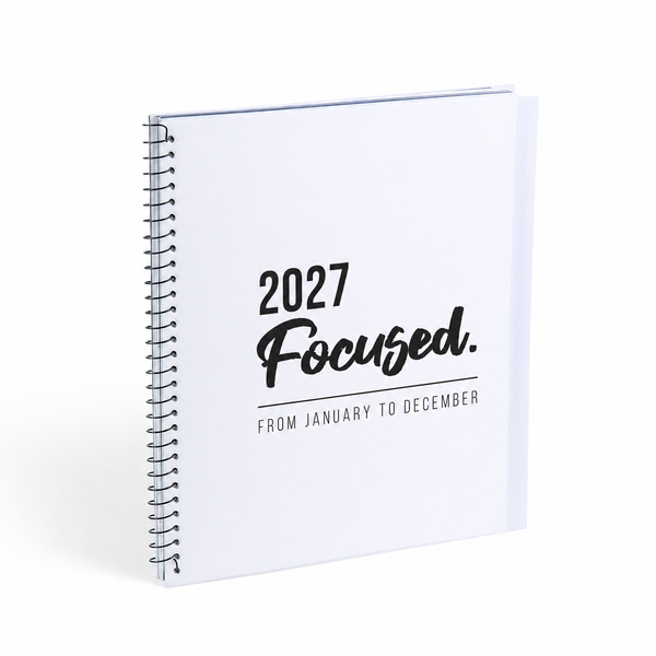 A white spiral-bound 2027 calendar or planner cover standing upright on a white background, with black text reading '2027 Focused. FROM JANUARY TO DECEMBER'.